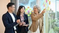 Professional senior Asian female boss training and giving project advice to her employees Royalty Free Stock Photo