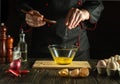 Professional chef adds salt while cooking the eggs. Work environment on the kitchen table. Menu idea for a restaurant or hotel Royalty Free Stock Photo