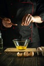 Professional chef adds salt while cooking the eggs. Work environment on the kitchen table. Menu idea for a restaurant or hotel Royalty Free Stock Photo