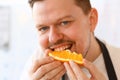 Professional Chef Bite Orange Slice Portrait Royalty Free Stock Photo