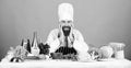 Professional chef in cook uniform. tired bearded man cooking in kitchen. Dieting with organic food. Fresh vegetables Royalty Free Stock Photo