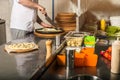 Professional chef cooking in the kitchen restaurant at the hotel, preparing dinner. A cook in an apron makes a salad of Royalty Free Stock Photo