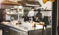 Professional chef cooking in the kitchen restaurant at the hotel, preparing dinner. A cook in an apron makes a salad of Royalty Free Stock Photo