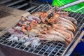 Professional Chef Cooking Prawns or shrimp grilled on charcoal stove. shrimp grilled bbq seafood on stove.