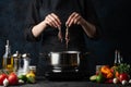 Professional chef cooking traditional asian dish with boiled seafood. Backstage of preparing meal on dark blur background. Concept Royalty Free Stock Photo