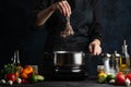 Professional chef cooking traditional asian dish and puts octopus into pot with boiling water. Backstage of preparing seafood on Royalty Free Stock Photo