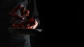 A professional chef cooks crayfish. Cooking seafood, healthy vegetarian food and meal on a dark background. Horizontal view