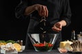 A professional chef cooks a fresh and healthy Italian salad, rubbing mazzarella cheese, freezing in motion. Organic and wholesome