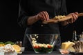 A professional chef cooks a fresh and healthy Italian salad sprinkling mazzarella cheese, Freezing in motion. Organic and