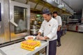 Professional chef cracking eggs at the kitchen