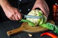 Professional chef cuts cauliflower in a restaurant kitchen before cooking. The idea of a delicious diet for breakfast or dinner Royalty Free Stock Photo