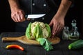 Professional chef is cutting cauliflower in a restaurant kitchen. The idea of a delicious diet for breakfast or dinner Royalty Free Stock Photo