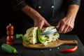 Professional chef is cutting cauliflower in a restaurant kitchen. The idea of a delicious diet for breakfast or dinner Royalty Free Stock Photo