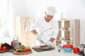 Professional chef cutting meat on table Royalty Free Stock Photo