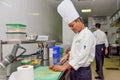 Professional chef cutting vegetables for a dish at the kitchen of the restaurant