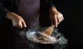 A professional chef fries hot dog sausages in a frying pan. Close-up of a cook hands with a hot pan in the kitchen. Free space for Royalty Free Stock Photo