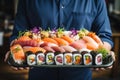 Professional Chef Holding a Delicious Variety of Sushi on a Plate in a Cozy Cafe Setting