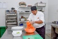 Professional chef mixing ingredients for salad in the bowl