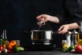 The professional chef out boiled octopus with a spoon from the pot. Backstage of cooking seafood for festive dinner at restaurant Royalty Free Stock Photo