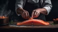 Professional chef prepares pieces of red fish salmon