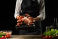 Professional chef prepares a salad of fresh shrimp, and vegetables on a dark background, freezing in motion. Seafood and healthy Royalty Free Stock Photo