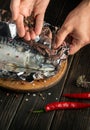 Professional chef prepares Scomber in the hotel kitchen. Before baking, mackerel must be wrapped in foil and spices added Royalty Free Stock Photo