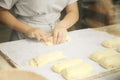 Professional chef rolling dough in the kitchen. Commercial bakery Royalty Free Stock Photo