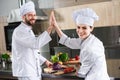Professional chefs giving high five Royalty Free Stock Photo