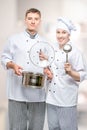 professional chefs with a pan and a ladle in a commercial kitchen