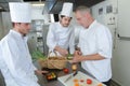 Professional chefs prepare steak dish at restaurant Royalty Free Stock Photo