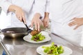 Professional chefs prepares steak dishes at restaurant Royalty Free Stock Photo