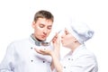 professional chefs try soup from a ladle on a white