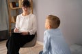 Professional child psychologist working with boy at office Royalty Free Stock Photo