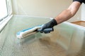 Professional cleaner using a washer sleeve to soap and clean a large fold-down window Royalty Free Stock Photo