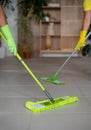 A professional cleaners wash the floor with a two mops. Royalty Free Stock Photo