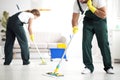 Professional cleaning crew washing floor
