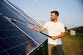 Professional cleaning. Man is working with solar panels outdoors at daytime Royalty Free Stock Photo