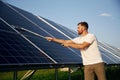 Professional cleaning. Man is working with solar panels outdoors at daytime Royalty Free Stock Photo