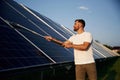 Professional cleaning. Man is working with solar panels outdoors at daytime Royalty Free Stock Photo