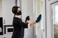 Professional Cleaning service company employee in rubber gloves remove dirt from windows using soft duster Royalty Free Stock Photo