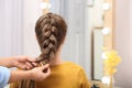 Professional coiffeuse braiding client`s hair Royalty Free Stock Photo