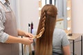 Professional coiffeuse braiding client`s hair Royalty Free Stock Photo