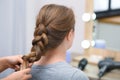 Professional coiffeuse braiding client`s hair Royalty Free Stock Photo