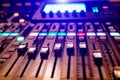 a professional concert mixing console with faders is used by a DJ for recording music. Close-up Royalty Free Stock Photo