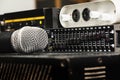 Professional condenser studio microphone over the musician blurred background and audio mixer, Musical instrument