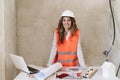 Professional confident architect woman in construction site working on blueprints. Home renovation Royalty Free Stock Photo