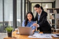 A professional Asian businesswoman or female manager is helping her colleague on a project Royalty Free Stock Photo