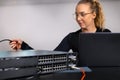IT technician professional configuring network switch and managing network cables and hardware in a data center Royalty Free Stock Photo