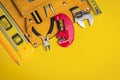 Professional construction tools for the master builder on yellow background