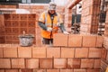 Professional construction worker, bricklayer and mason building house Royalty Free Stock Photo